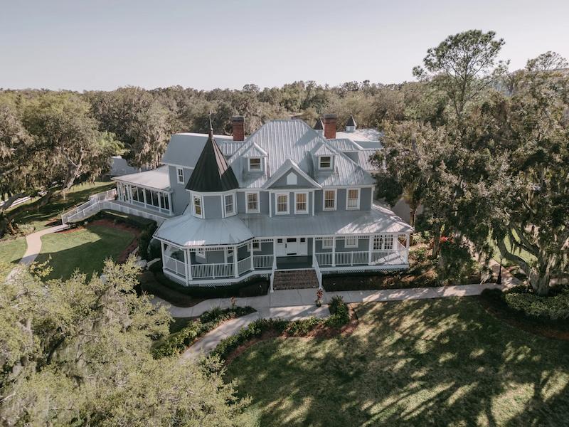 The Highland Manor historic estate exterior with century-old oak trees and manicured grounds