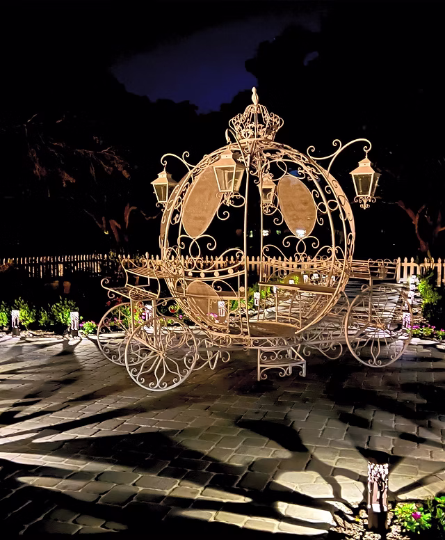 MiaBella Gardens rustic barn interior featuring crystal chandeliers and exposed wooden beams